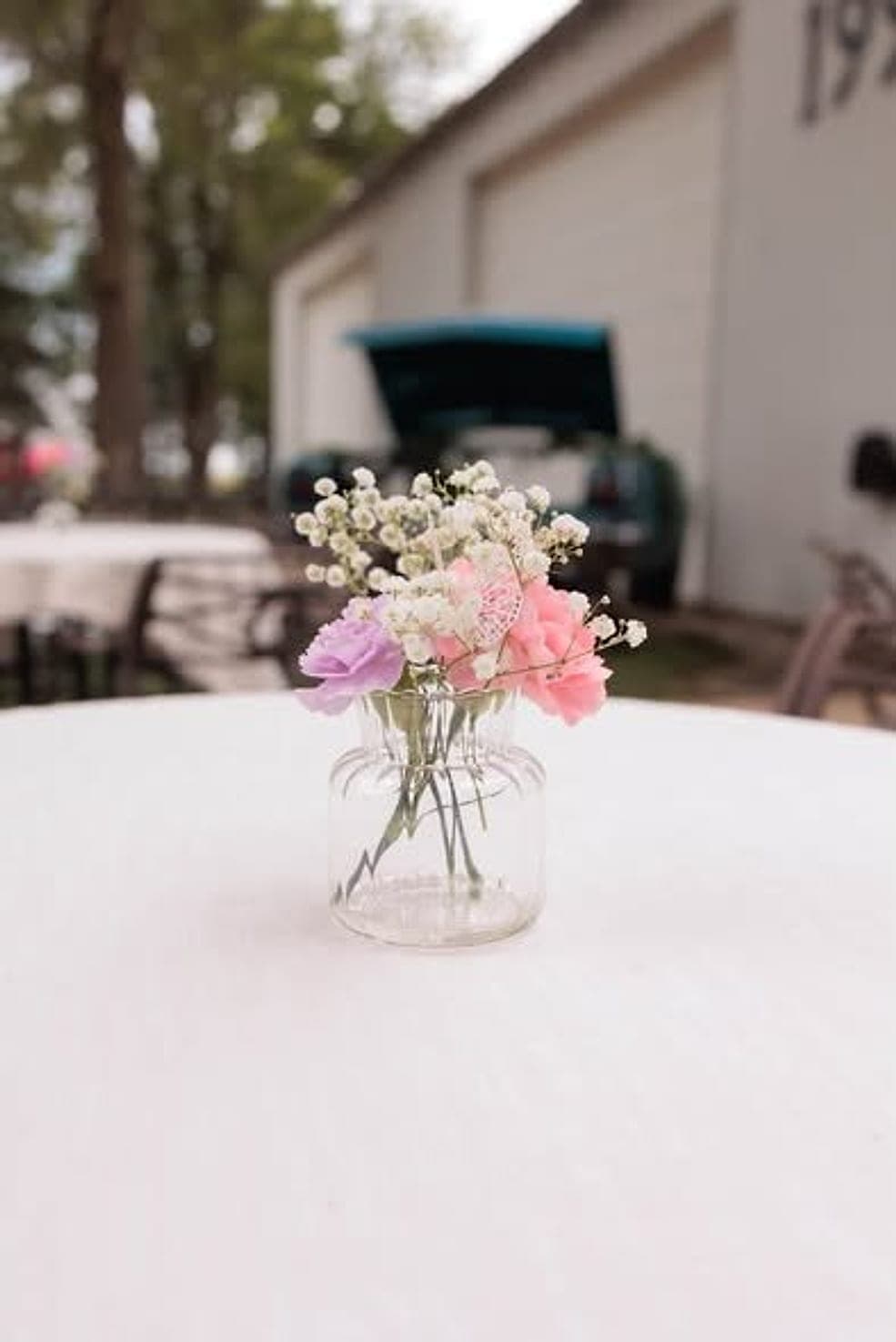 Pink and lavender flowers in a small glass vase